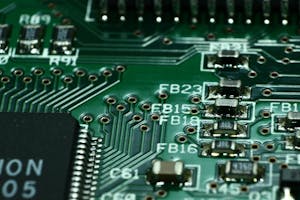 Detailed macro view of a circuit board showcasing microchips and electronic components.